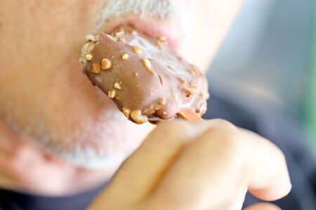 Senior man eating ice creamの写真素材