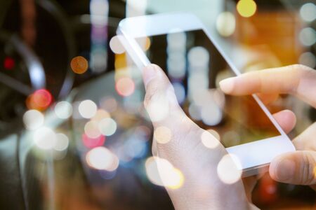 image of using a mobile phone inside of a car. communication networkingの写真素材