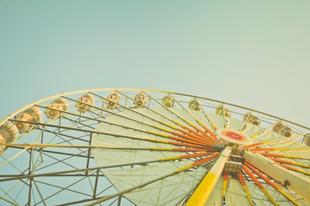 ferris wheel against a blue sky in vintage styleの写真素材
