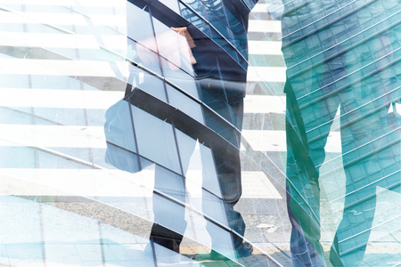 Abstract double exposure of businessman and office buildingsの写真素材