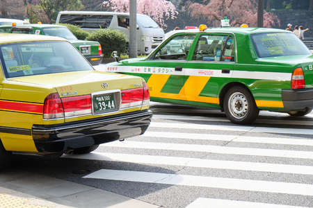TOKYO, JAPAN - APRIL5, 2017 :Taxi cars on the street near the ueno station in Tokyo on APRIL5, 2017 in Tokyo, Several taxi cabs are waiting in line along the sidewalk.のeditorial素材