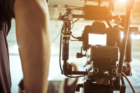 Cameraman with his video camera shooting, Adjusting Camera,film production crew,behind the scenes...