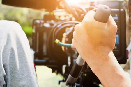 Cameraman with his video camera shooting, Hands Adjusting Camera,film production crew, behind the...