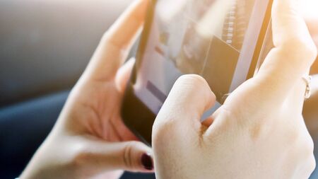 digital tablet, close up of hand typing on digital tableの写真素材