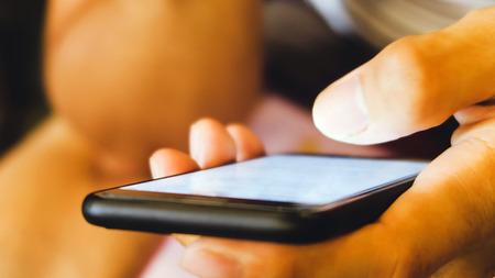 Close up of man's hands holding cell telephone