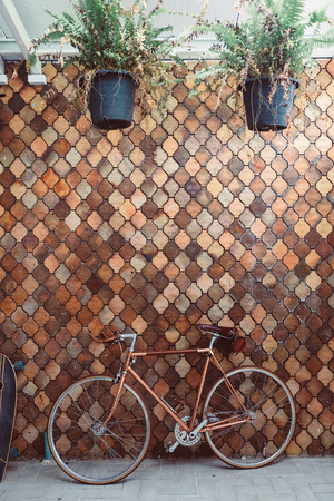 old bicycle parked on old mosaic wall vintageの写真素材