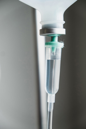 Close up of IV saline solution drip for patient in hospitalの写真素材