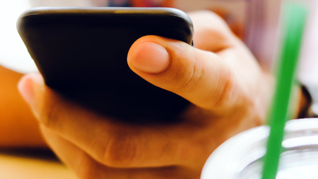 Closeup Image of man's hand holding a smartphoneの写真素材