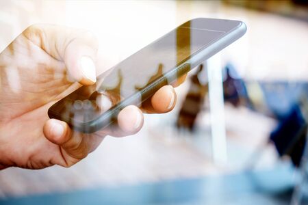 Hands with mobile, double exposureの写真素材