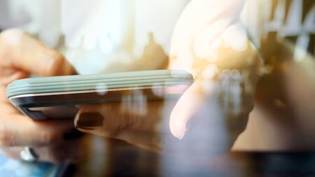 Hands with mobile, double exposureの写真素材