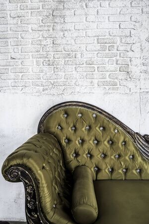 antique sofa on brick wall backgroundの写真素材