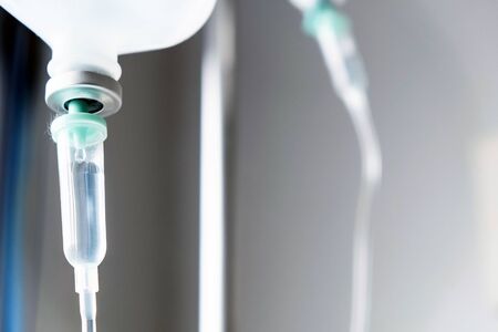 Close up of IV saline solution drip for patient in hospitalの写真素材