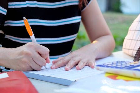 Close up female hands of accountant with calculator and pen. business accounting background.の写真素材