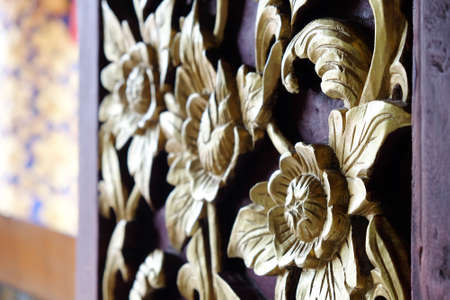Detail of wood carved window decoration at Phuket temple in Pua district, Nan province, Thailandの写真素材