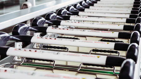 Image of Luggage trolley in a row at the airport