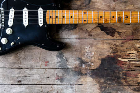Detail of Black Electric Guitar on a wood background.の写真素材