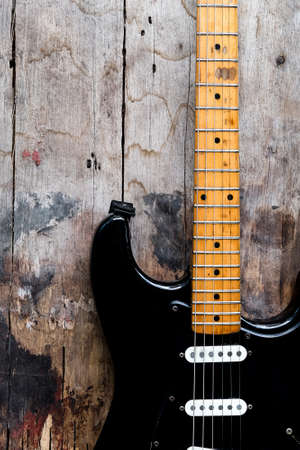 Detail of Black Electric Guitar on a wood background.の写真素材