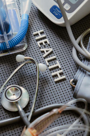Concept image of Health background, health letters and medical equipment on gray background.
