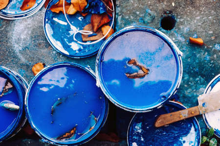 Top view of bucket with blue paint and brushの写真素材