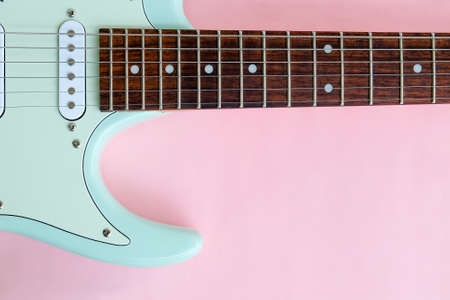 Detail of Mint Green Electric Guitar on a Pink background.の写真素材