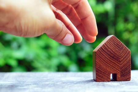 wood house model on wood table with green nature background , eco house icon concept.の写真素材