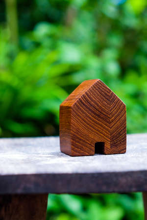 wood house model on wood table with green nature background , eco house icon concept.の写真素材