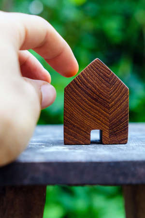 wood house model on wood table with green nature background , eco house icon concept.の写真素材
