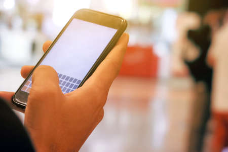 Closeup Image of man checking his phoneの写真素材