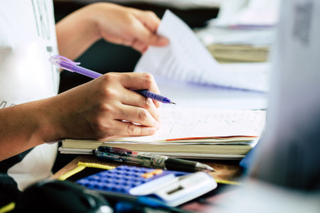 Close up female hands of accountant with calculator and pen. business accounting background.の写真素材