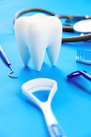 Close up image of dentist tools and white tooth on blue background.の写真素材