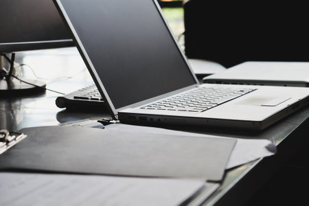 Laptop and papers on desk close upの写真素材