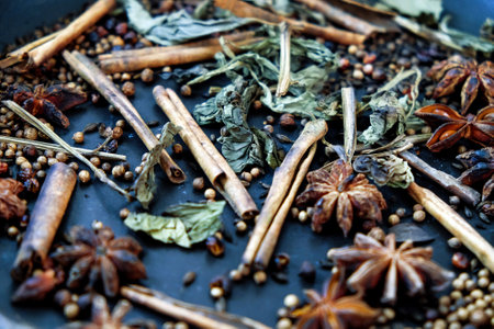 spices in a pan, A spice is a seed, fruit, root, bark, or other plant substance primarily used for flavoring or coloring food. Spices are sometimes used in medicine, cosmeticsの写真素材