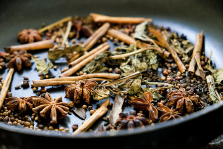 spices in a pan, A spice is a seed, fruit, root, bark, or other plant substance primarily used for flavoring or coloring food. Spices are sometimes used in medicine, cosmeticsの写真素材