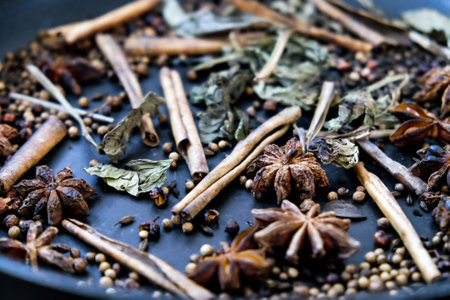 spices in a pan, A spice is a seed, fruit, root, bark, or other plant substance primarily used for flavoring or coloring food. Spices are sometimes used in medicine, cosmeticsの写真素材
