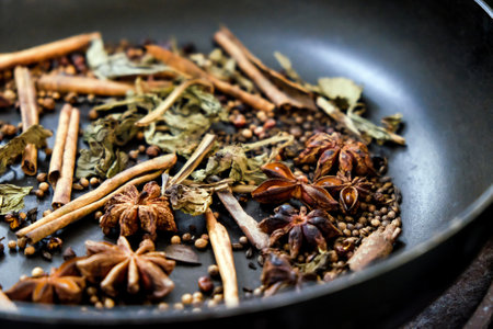 spices in a pan, A spice is a seed, fruit, root, bark, or other plant substance primarily used for flavoring or coloring food. Spices are sometimes used in medicine, cosmeticsの写真素材