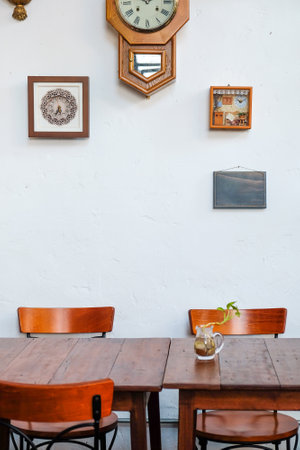 Wooden table and chair in coffee shop with white wall background.の写真素材