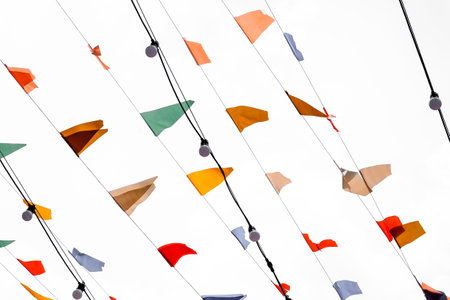 Colourful flags on a string in the wind on a white backgroundの写真素材