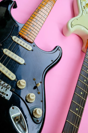 Electric guitar on a pink background, close-up, top viewの写真素材