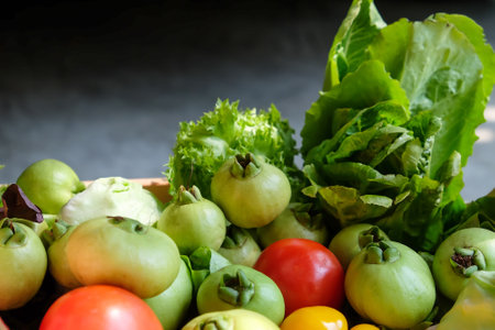 Vegetables in a basket on a dark background. Healthy food.の写真素材