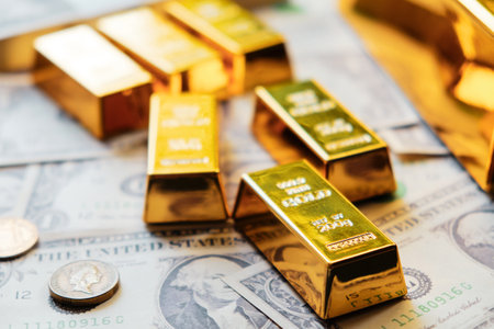 Gold bars on the background of dollar bills. The concept of wealth