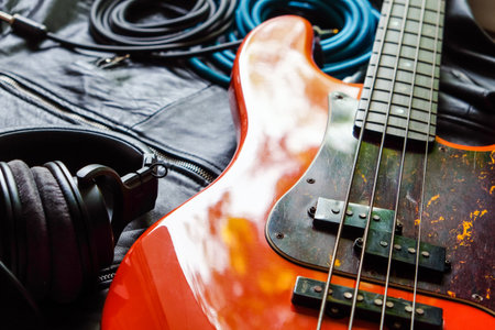 Electric guitar and headphones on a dark background. Close-up.