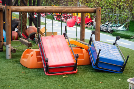 Empty playground with various equipment and toys on green synthetic grassの写真素材