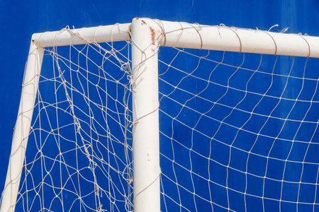 Close-up of a soccer goal net on a blue background.の写真素材