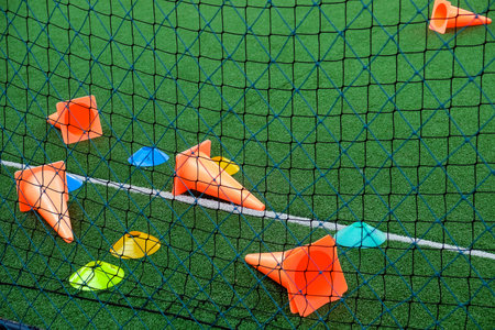 Soccer cones on green artificial turf, sport background.の写真素材