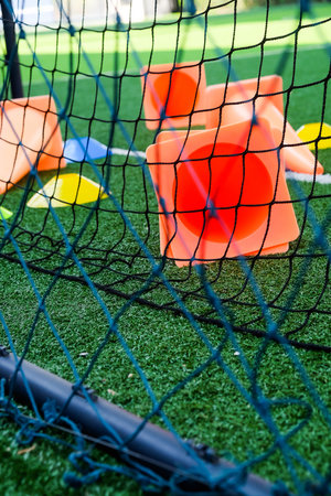 Soccer cones on green artificial turf, sport background.の写真素材