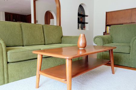 Interior of a modern living room with a green sofa and a coffee tableの写真素材