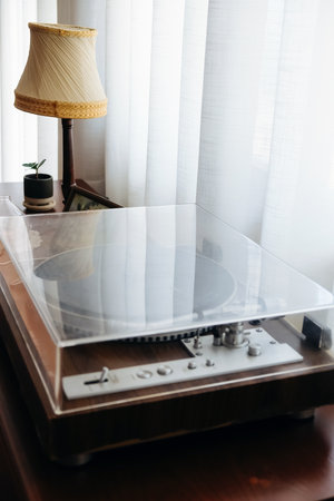 Vintage vinyl record player on table in living room at home.の写真素材