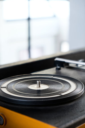 Vintage vinyl record player on table in living room at home.の写真素材