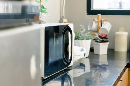 Microwave oven on the table in the kitchen at home.の写真素材