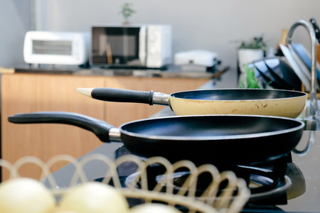 Frying pan on the stove in a modern kitchen.の写真素材